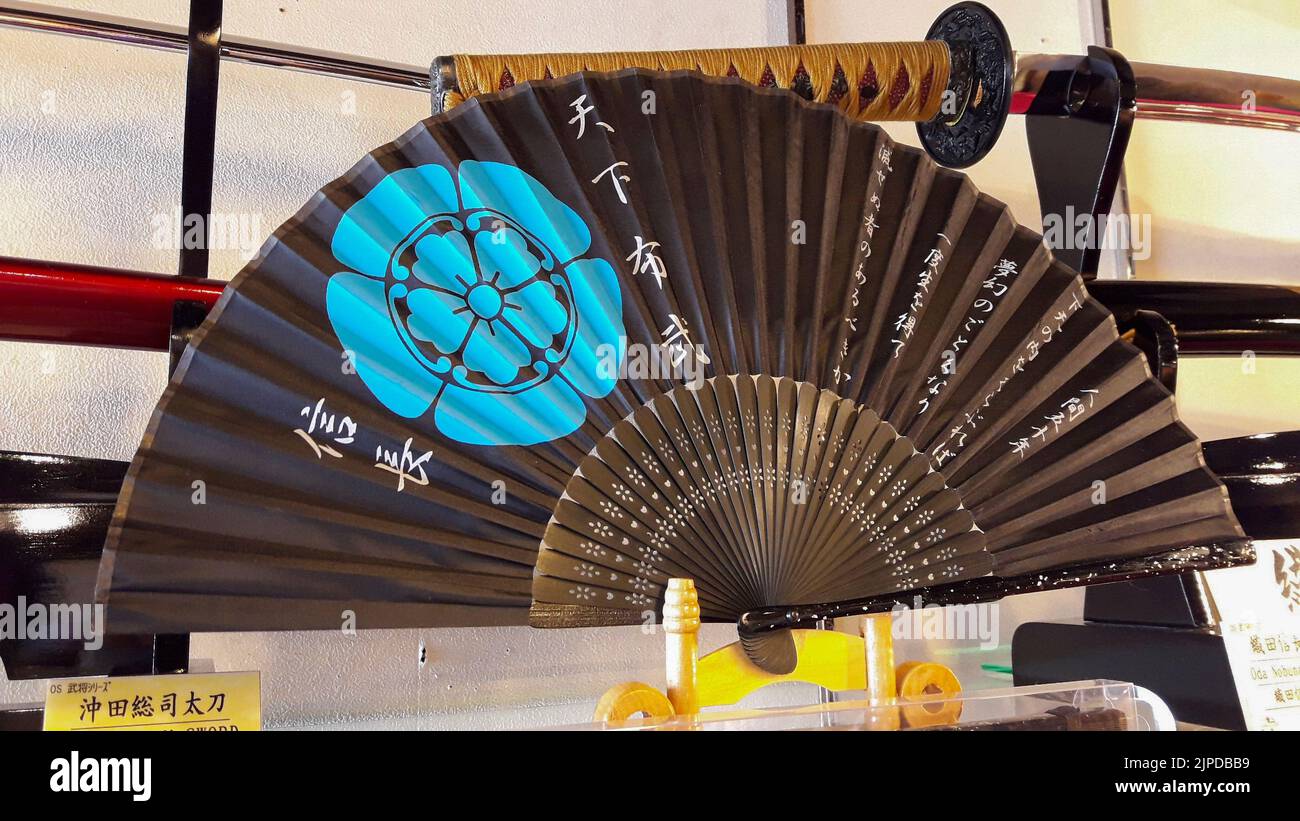 A closeup of a fan with the family crest of a Japanese warlord sold in a store Stock Photo