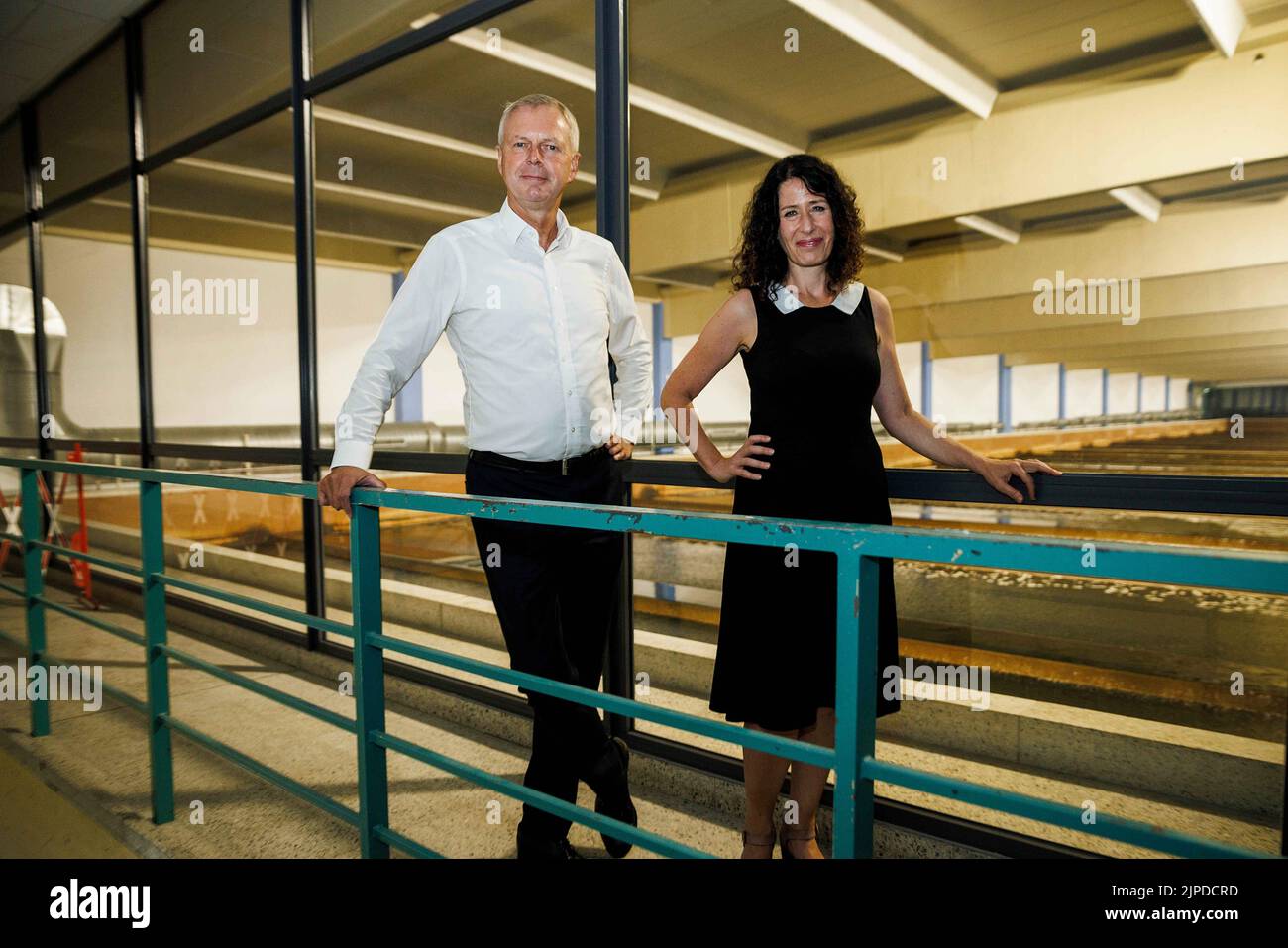 Berlin, Germany. 17th Aug, 2022. Bettina Jarasch (r, Bündnis 90/Die Grünen), Berlin Senator for the Environment, Transport, Climate and Consumer Protection, and Frank Bruckmann, CEO and CFO of Berliner Wasserbetriebe, stand in the filter hall at the Tegel waterworks after a press conference on the careful use of water. Credit: Carsten Koall/dpa/Alamy Live News Stock Photo