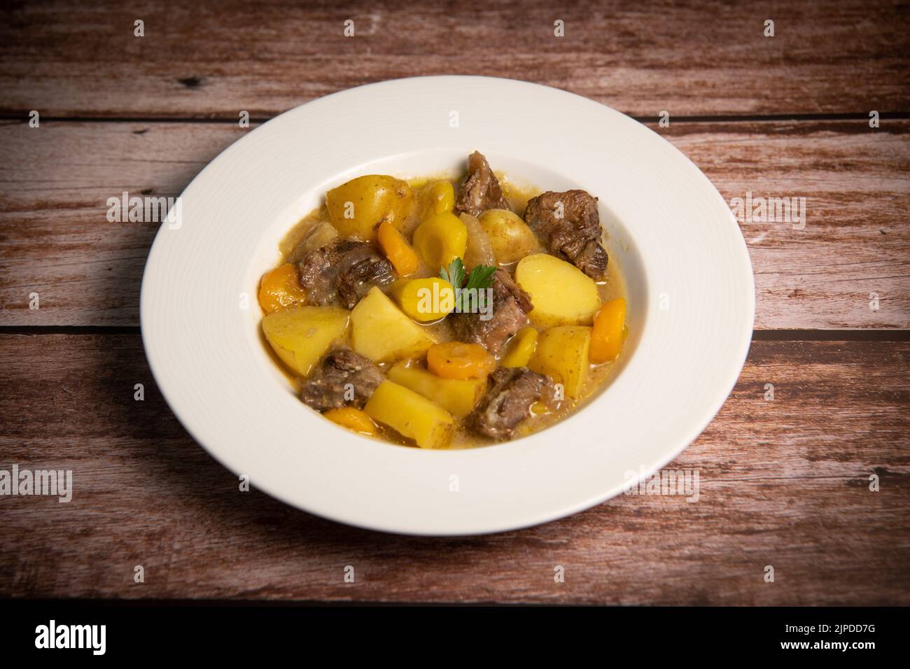 Recipe for beer and mustard beef chuck stew with potatoes, turnips and carrots Stock Photo Alamy