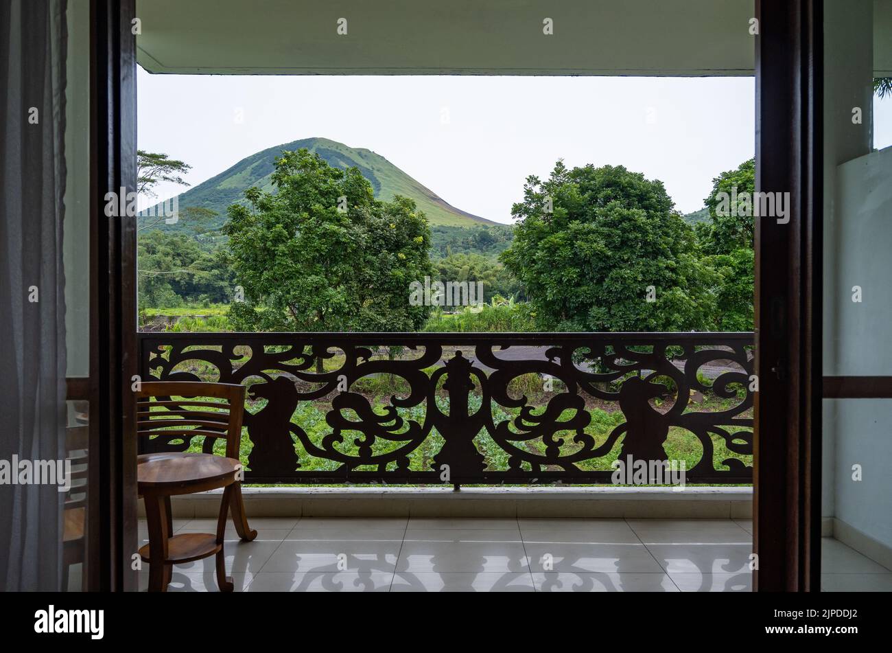 View from a hotel room of the Mount Lokon, or Gunung Lokon, an active volcano near Tomohon, North Sulawesi, Indonesia. Stock Photo