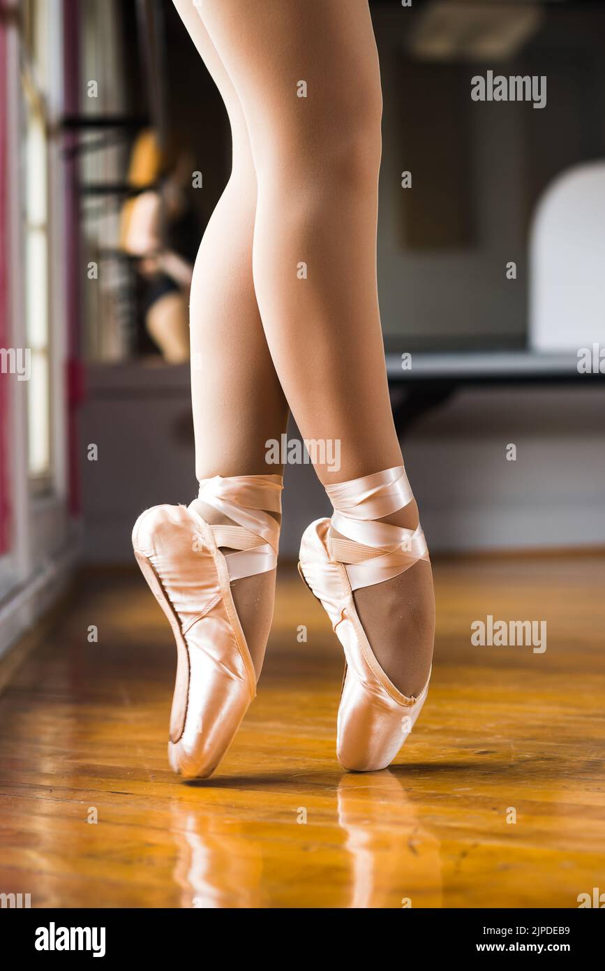Window lit legs of a ballerina in pointe shoes Stock Photo Alamy