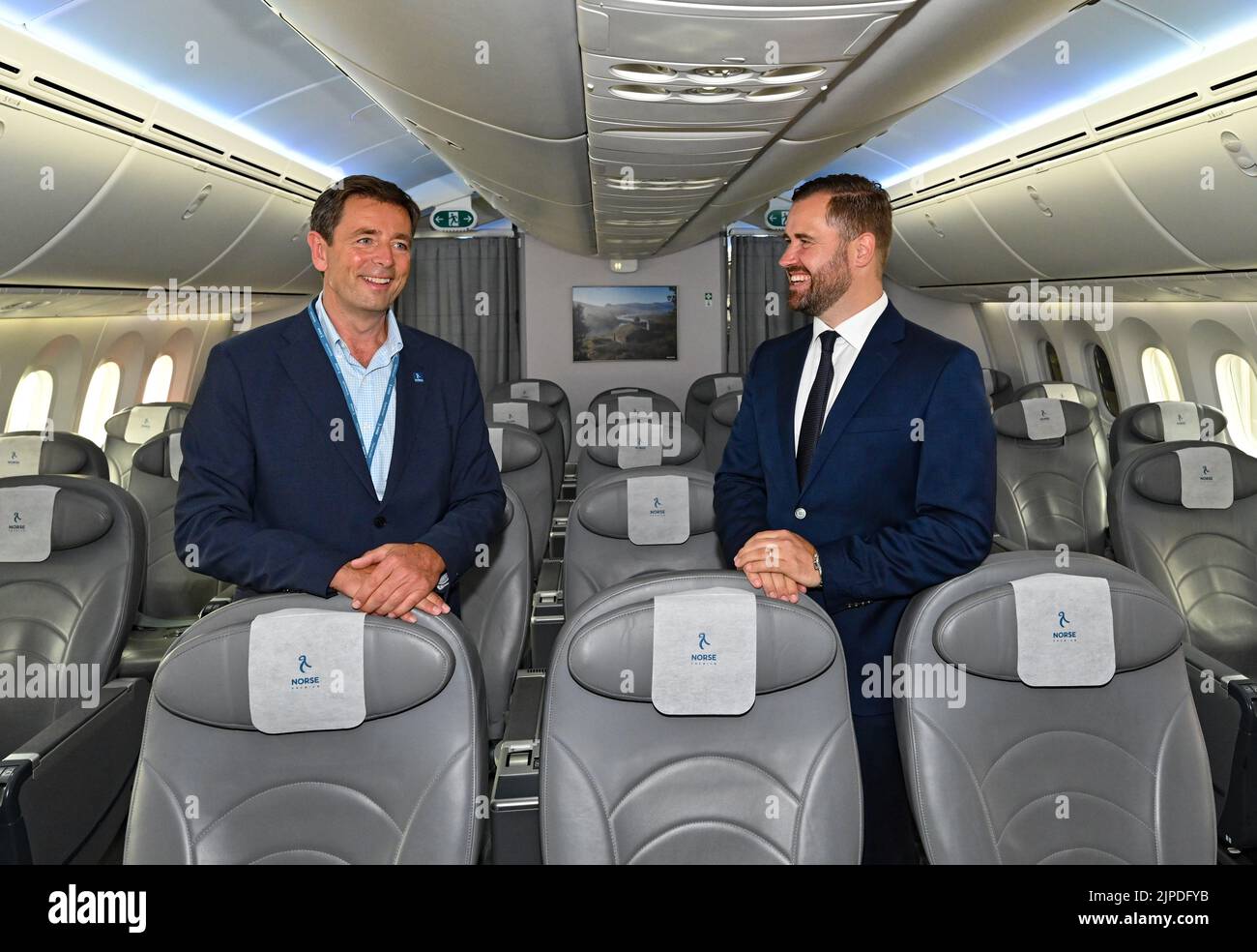 17 August 2022, Brandenburg, Schönefeld: Björn Tore Larsen (l), CEO of Norse Atlantic Airways, and Thomas Hoff Andersson, Managing Director for Airport Operations at BER, stand in a Boeing 787 Dreamliner before the first flight from the capital's airport BER to New York (JFK). The airline Norse Atlantic Airways will launch its first flight from BER Airport to New York (JFK) on August 17. Photo: Patrick Pleul/dpa Stock Photo