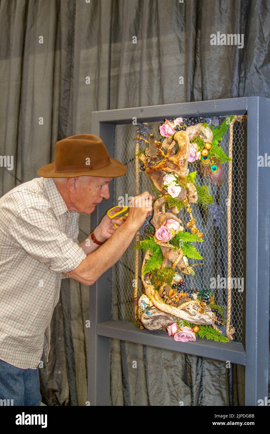 Southport Flower Show, Merseyside, UK. 17th Aug 2022:  Ken Hough with his Floral Art exhibit 'Lifes Rich Tapestry' at the largest independent flower show in England, which is expecting thousands of visitors over the four-day event as it opens tomorrow after a two-year closure.  Credit: MediaWorld Images/Alamy Live News Stock Photo