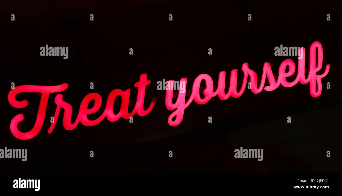 Treat Yourself, red / pink sign Stock Photo