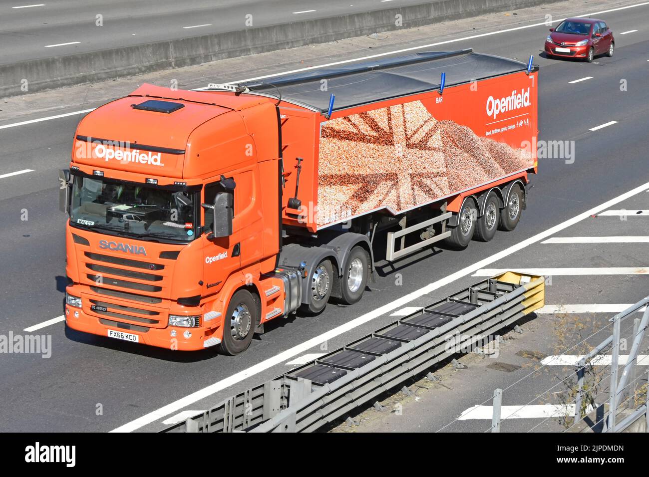 Openfield hgv lorry truck British grain marketing & arable inputs co-operative business brand logo on covered articulated trailer on UK motorway road Stock Photo
