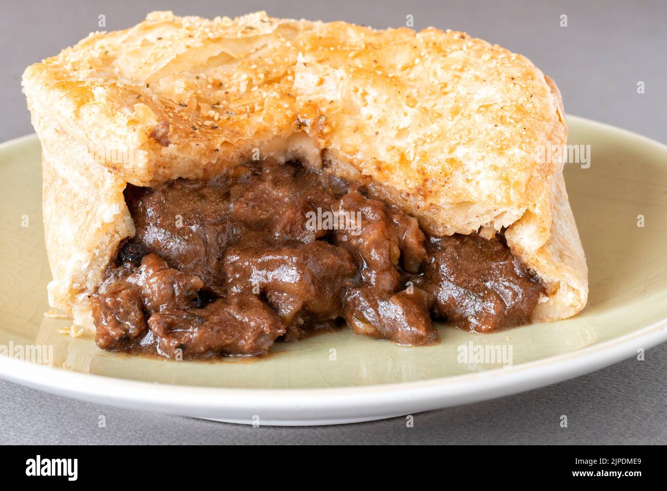 A supermarket bought steak meat shortcut pastry pie. A popular ready to eat shop bought treat that is sometimes regarded as an ultra processed food Stock Photo