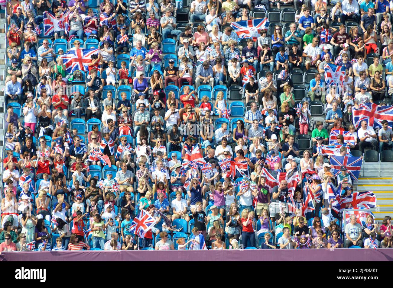 Adults children and families at London 2012 Paralympic games spectators seated in temporary stands to watch football event hot summer day England UK Stock Photo
