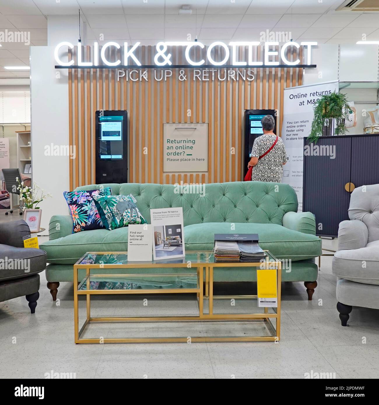 M&S customer Click & Collect pick up & returns facility with furniture display in large Marks and Spencer retail shopping business store in England UK Stock Photo