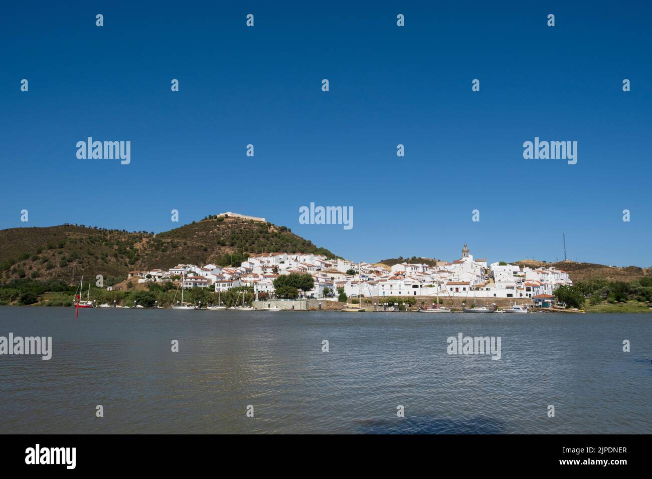 Spanish village of San Lucar de Guadiana on the Guadiana river seen from the Portuguese village of Alcoutim. Stock Photo