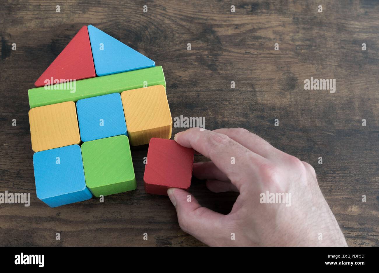 building house with wooden toy blocks, real estate concept Stock Photo