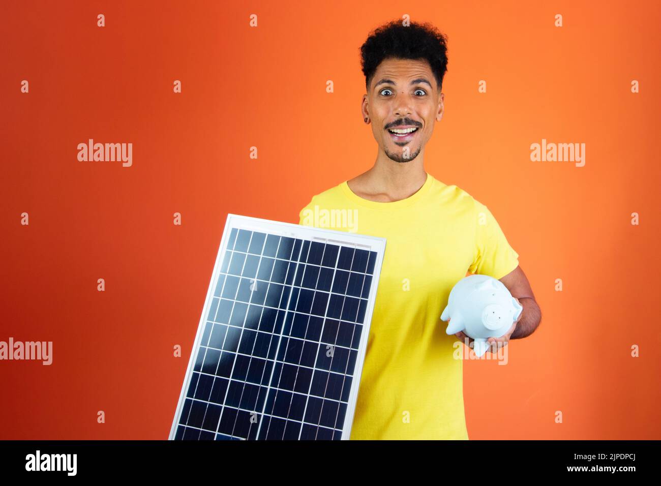 Handsome Black Man Holding a Piggy Bank and Solar Panel Isolated on ...