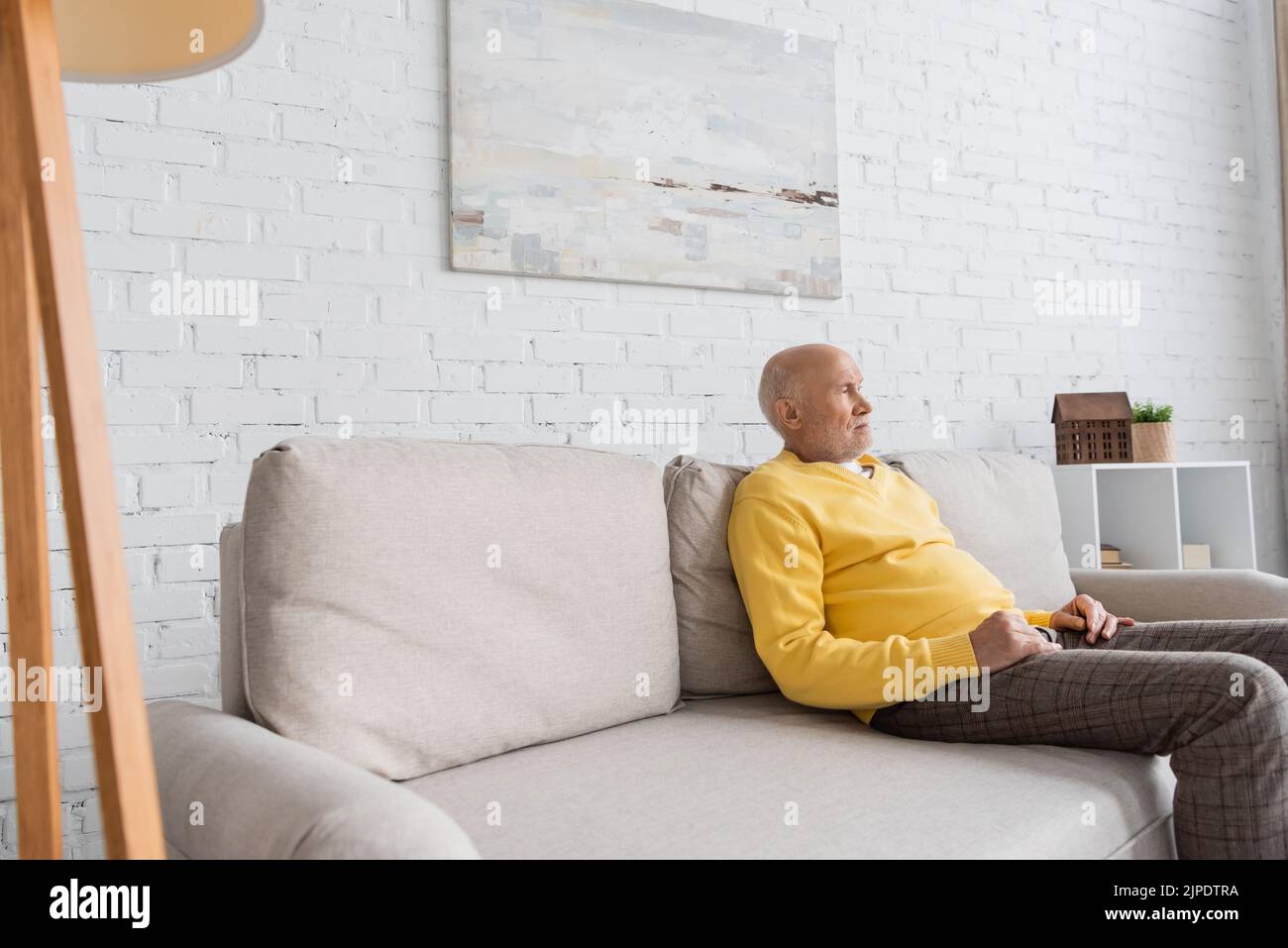 Sad senior man sitting on couch hi-res stock photography and images - Alamy
