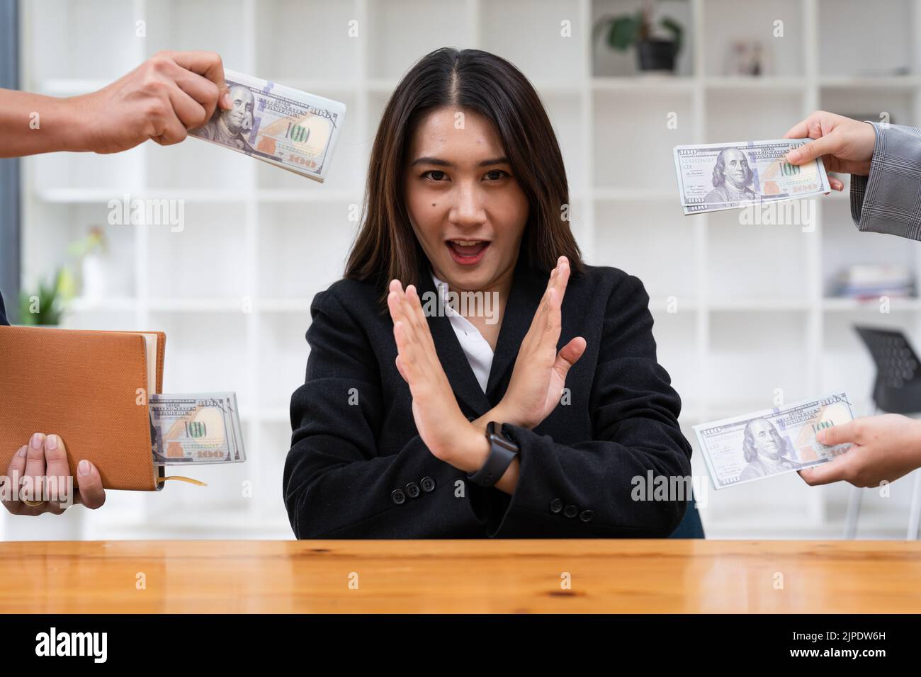 Asian woman refusing money in the envelope to agreement contract, Bribe and corruption concept Stock Photo