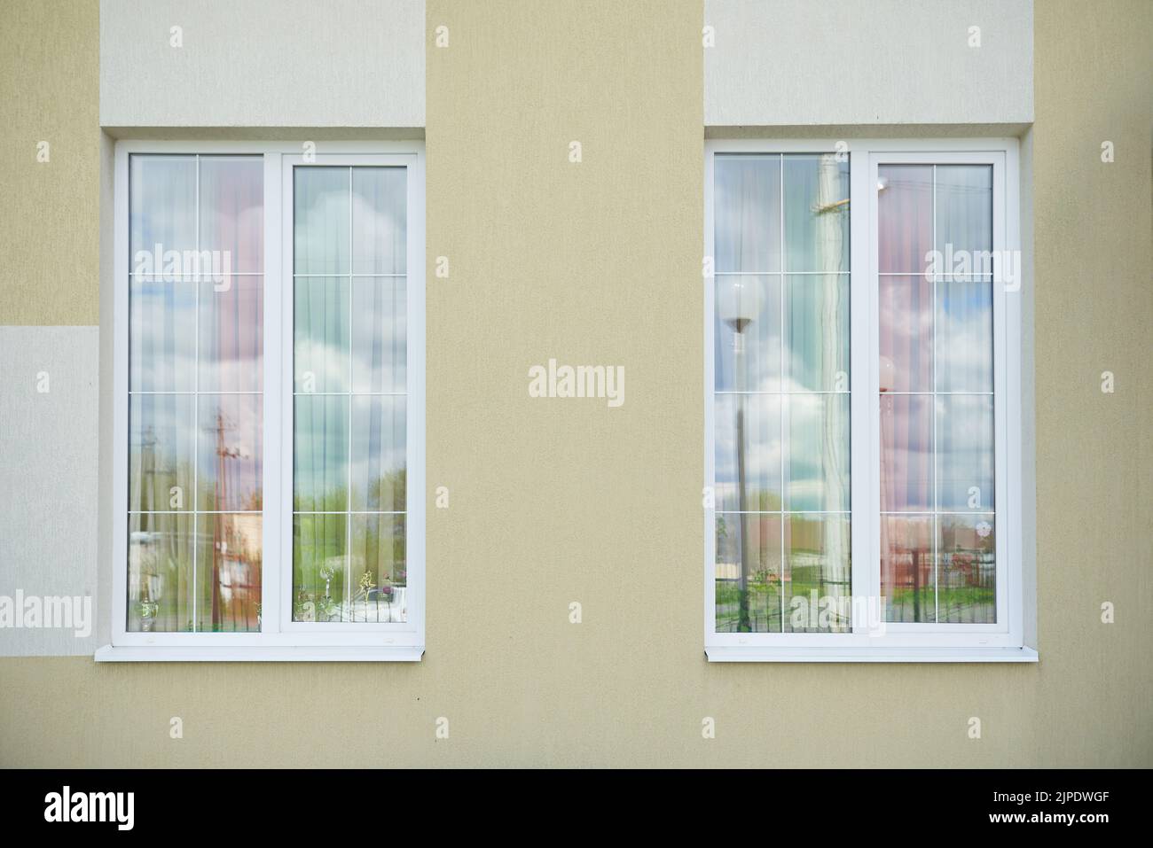 Two white plastic high windows with partitions Stock Photo