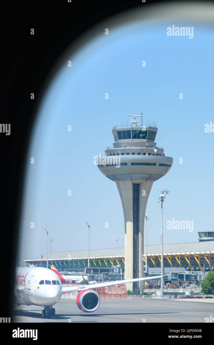 Tower of the Adolfo Suárez Madrid–Barajas Airport or Madrid–Barajas Airport during the daytime. Point of view of a passenger inside a plane Stock Photo