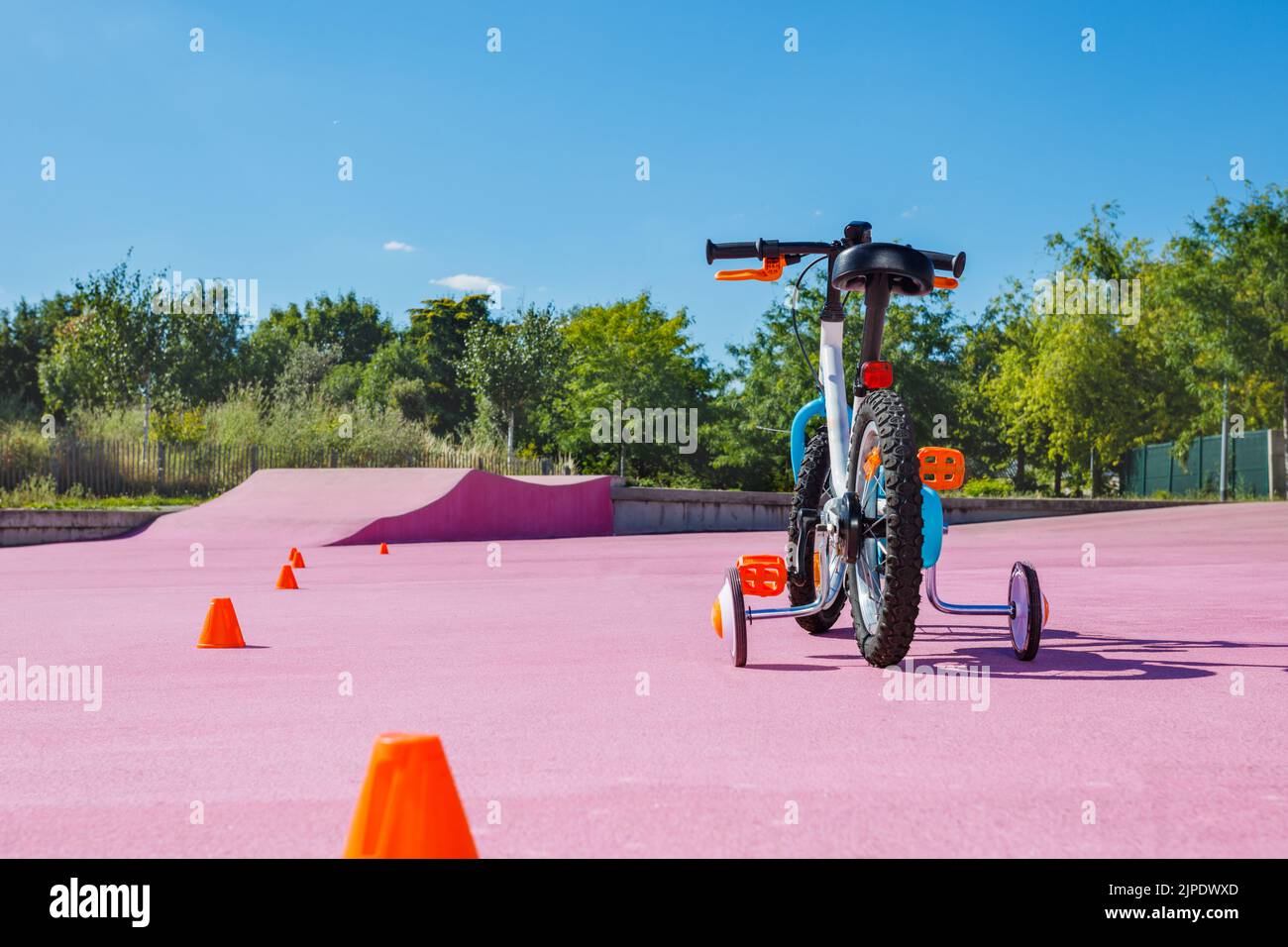 Learning a bike concept baby bicycle with extra wheels Stock Photo