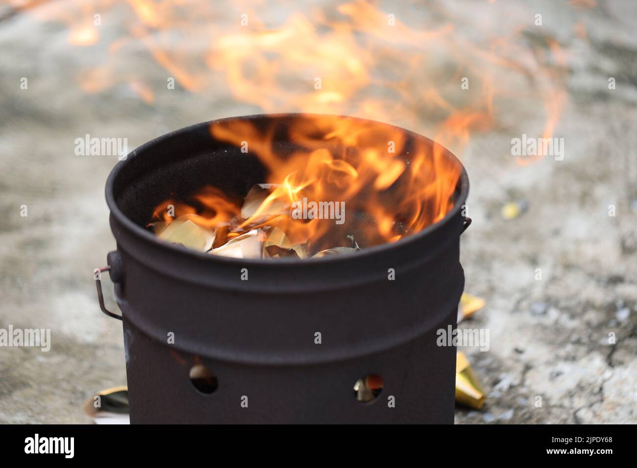 The culture of Chinese people in Thailand burning paper for the pass family to pray for luck. Stock Photo