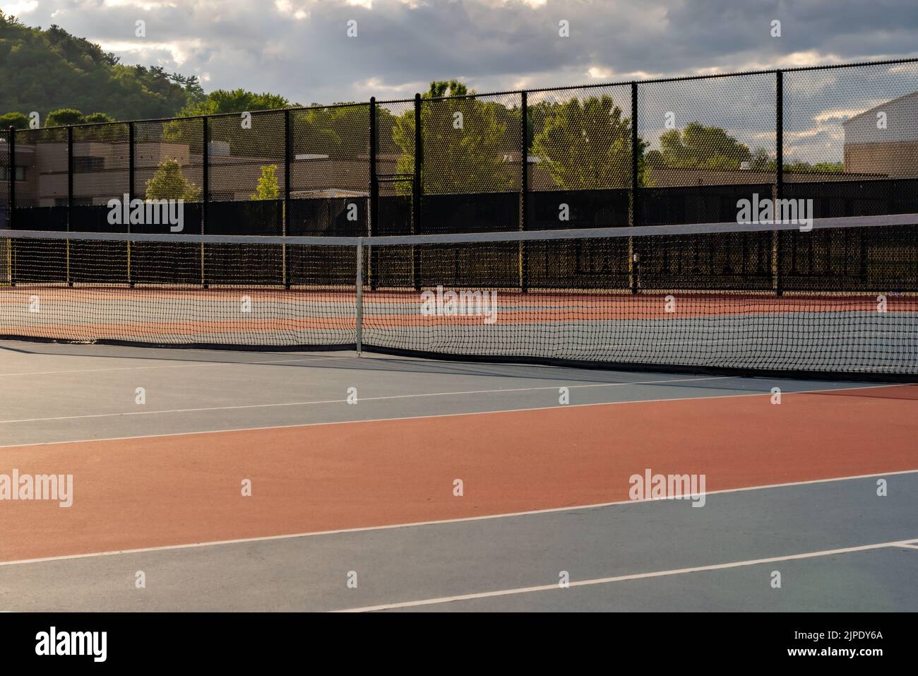 New blue outdoor tennis courts with white lines and red out of play