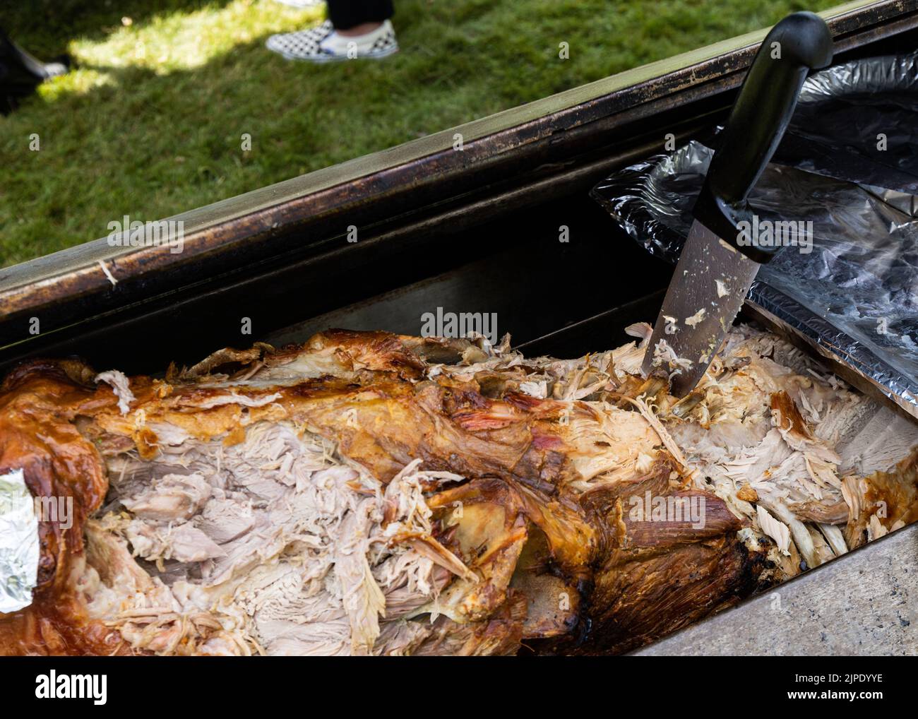 A partly carved hog roast at a Summer barbecue Stock Photo