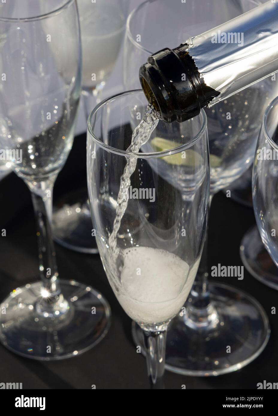 Glasses of Prosecco sparkling white wine poured at an event or social occasion Stock Photo