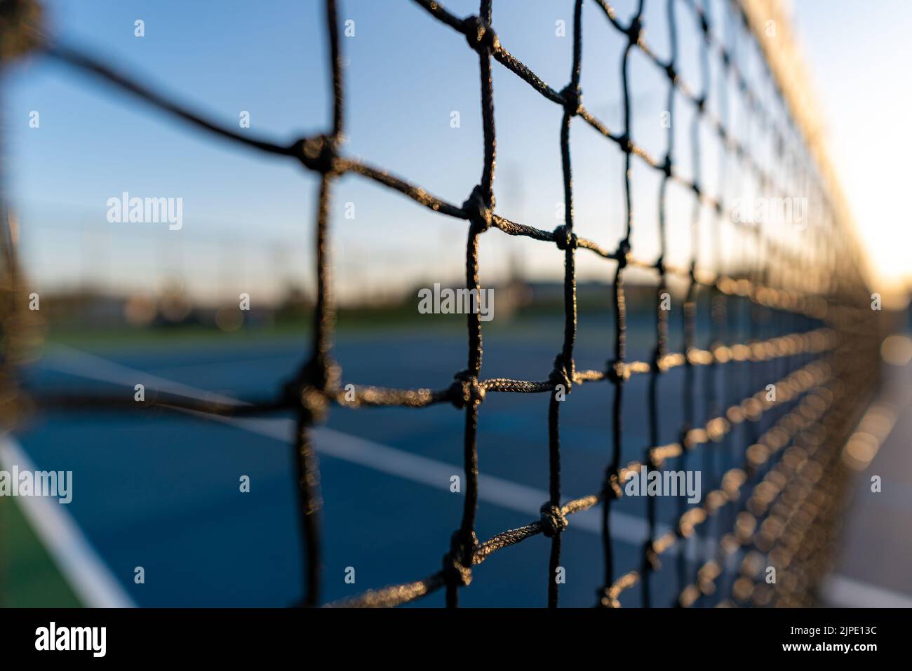 Late afternoon close up photo of new outdoor tennis court net Stock