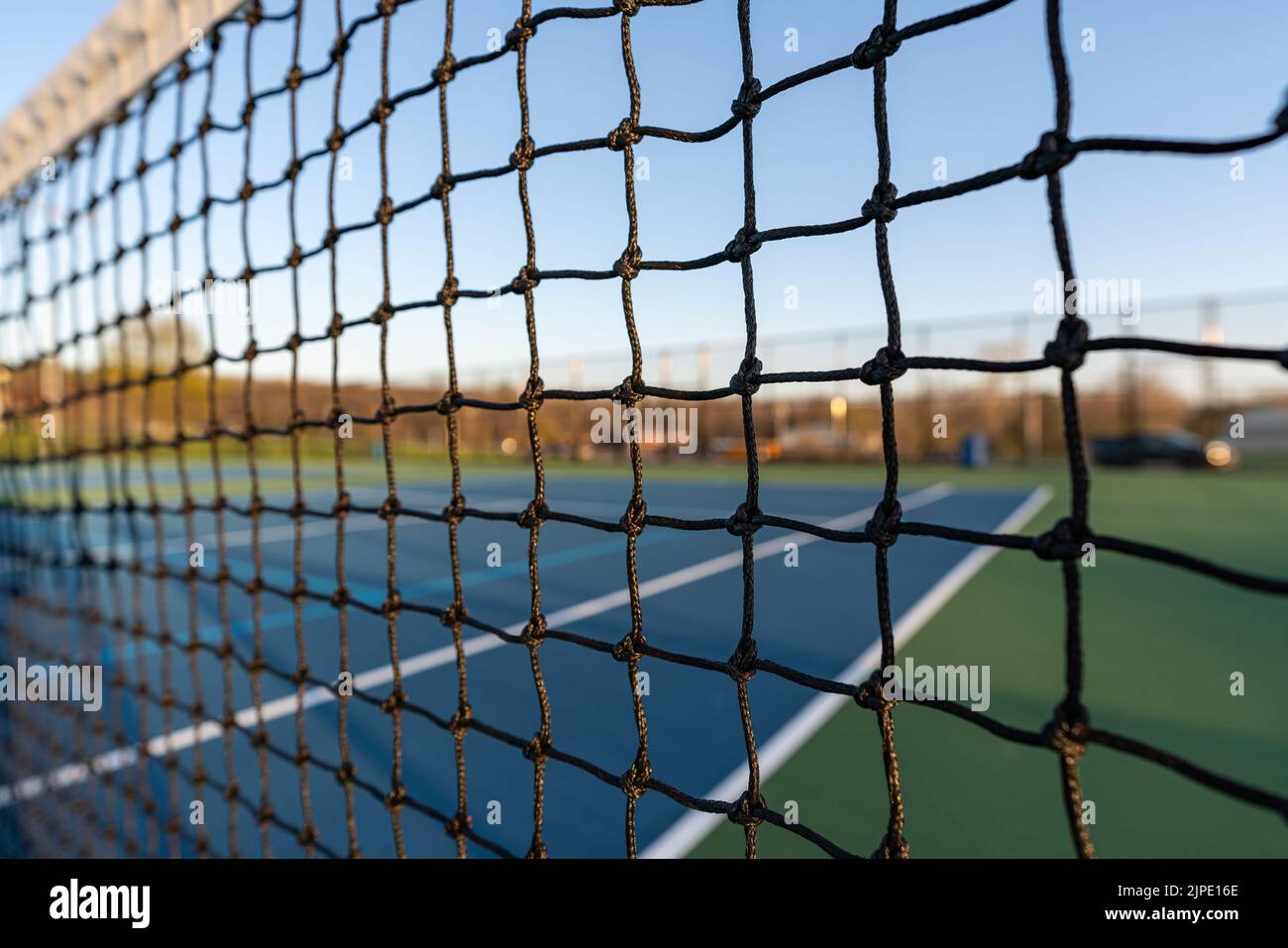 Late afternoon close up photo of new outdoor tennis court net Stock