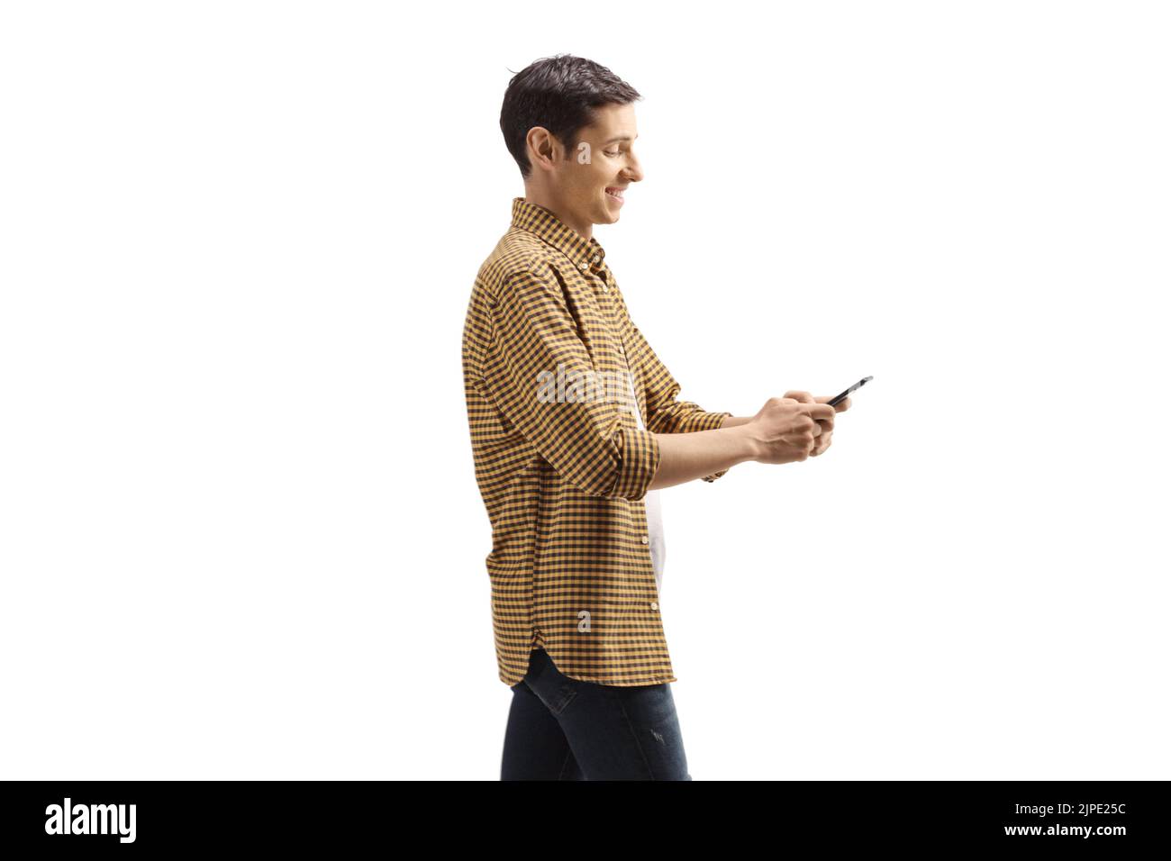 Young man in shirt and jeans using a mobile phone isolated on white background Stock Photo