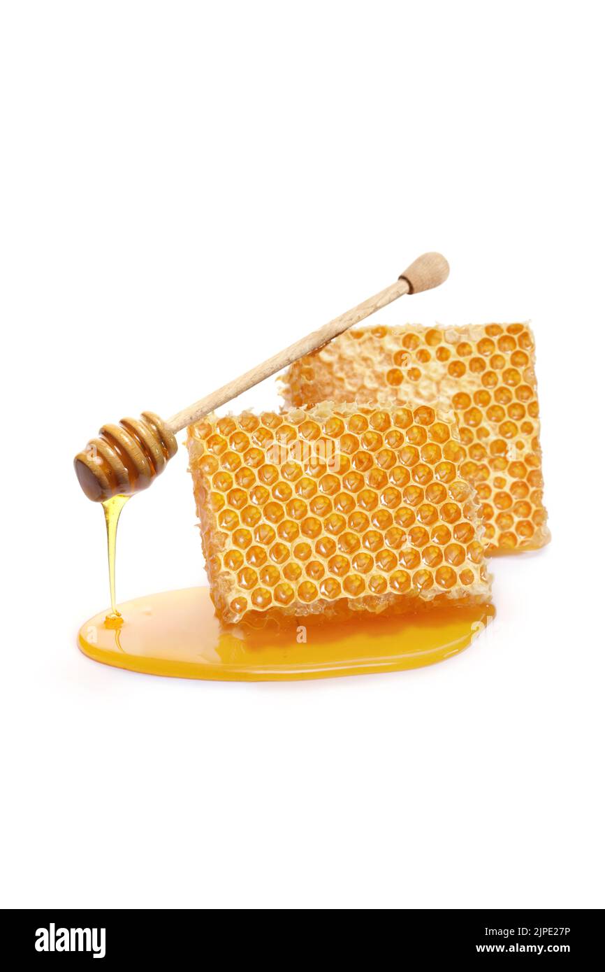 Pieces of a honeycomb with a honey dipper isolated on white background Stock Photo