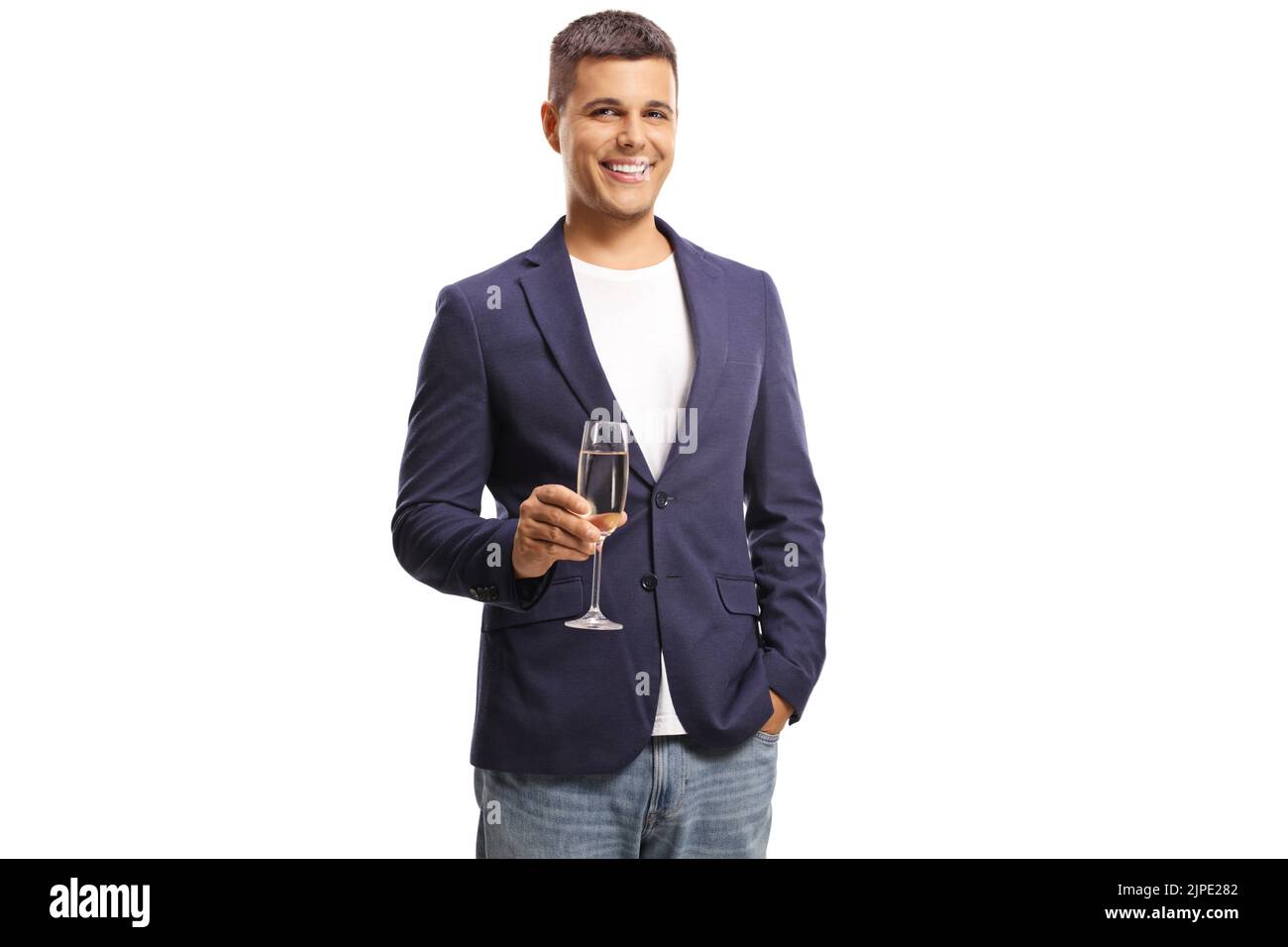 Smiling young man holding a glass of champagne isolated on white background Stock Photo