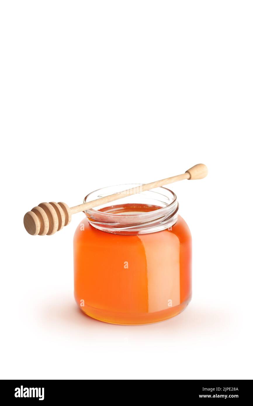 Studio shot of an open honey jar with a honey dipper isolated on white background Stock Photo