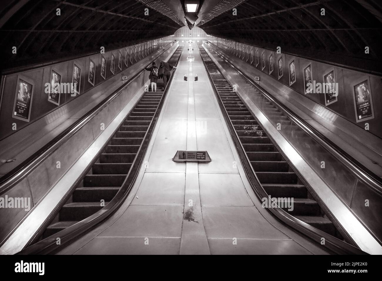 A monochrome picture of a pair of escalators in a London Underground tube station. Stock Photo