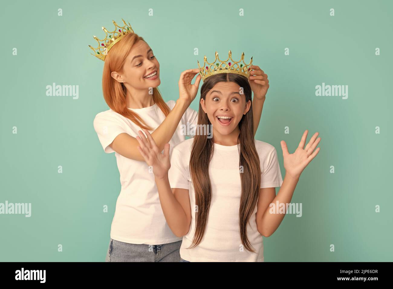 This is a happy surprise. Surprised child win crown. Happy mother crown daughter. Pageant girl Stock Photo