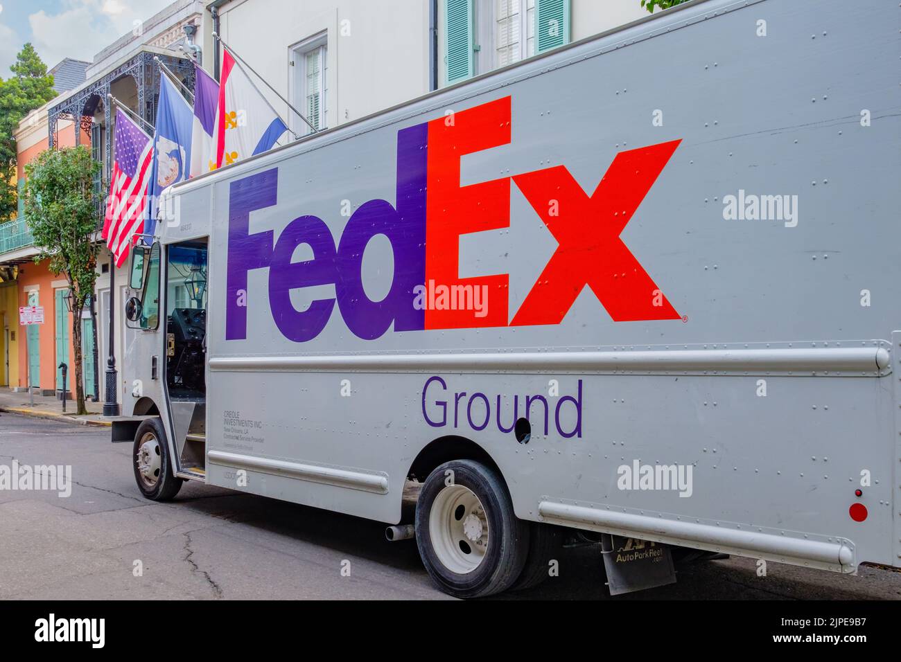 NEW ORLEANS, LA, USA - AUGUST 14, 2022: Full side view of FedEx van as it makes a delivery on Chartres Street in the French Quarter Stock Photo