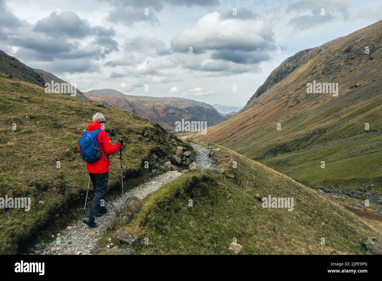 Hill walker on the path past Grains Gill from Great End towards Seathwaite, Lake District National Park, Cumbria, UK landscapes Stock Photo