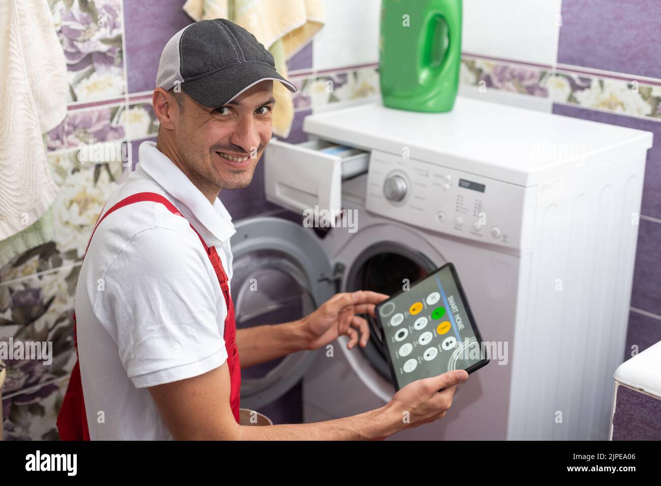 Controlling the washing machine with smartphone app Stock Photo Alamy