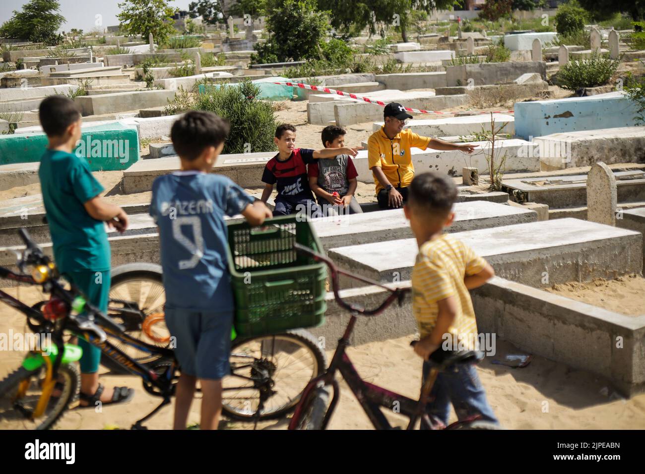 Gaza, Palestine. 17th Aug, 2022. Relatives of five Palestinian children killed during the recent fighting between Israel and Gaza gather near their graves, in Jabalia in the northern Gaza Strip. Israel has admitted to killing five Palestinian children in an air raid on the Fallujah cemetery in the town of Jabalia, in the northern Gaza Strip, on August 7th, after initially claiming they were killed as a result of a missile fired by Islamic Jihad, Israel's Haaretz newspaper reported. (Photo by Mahmoud Issa/SOPA Images/Sipa USA) Credit: Sipa USA/Alamy Live News Stock Photo