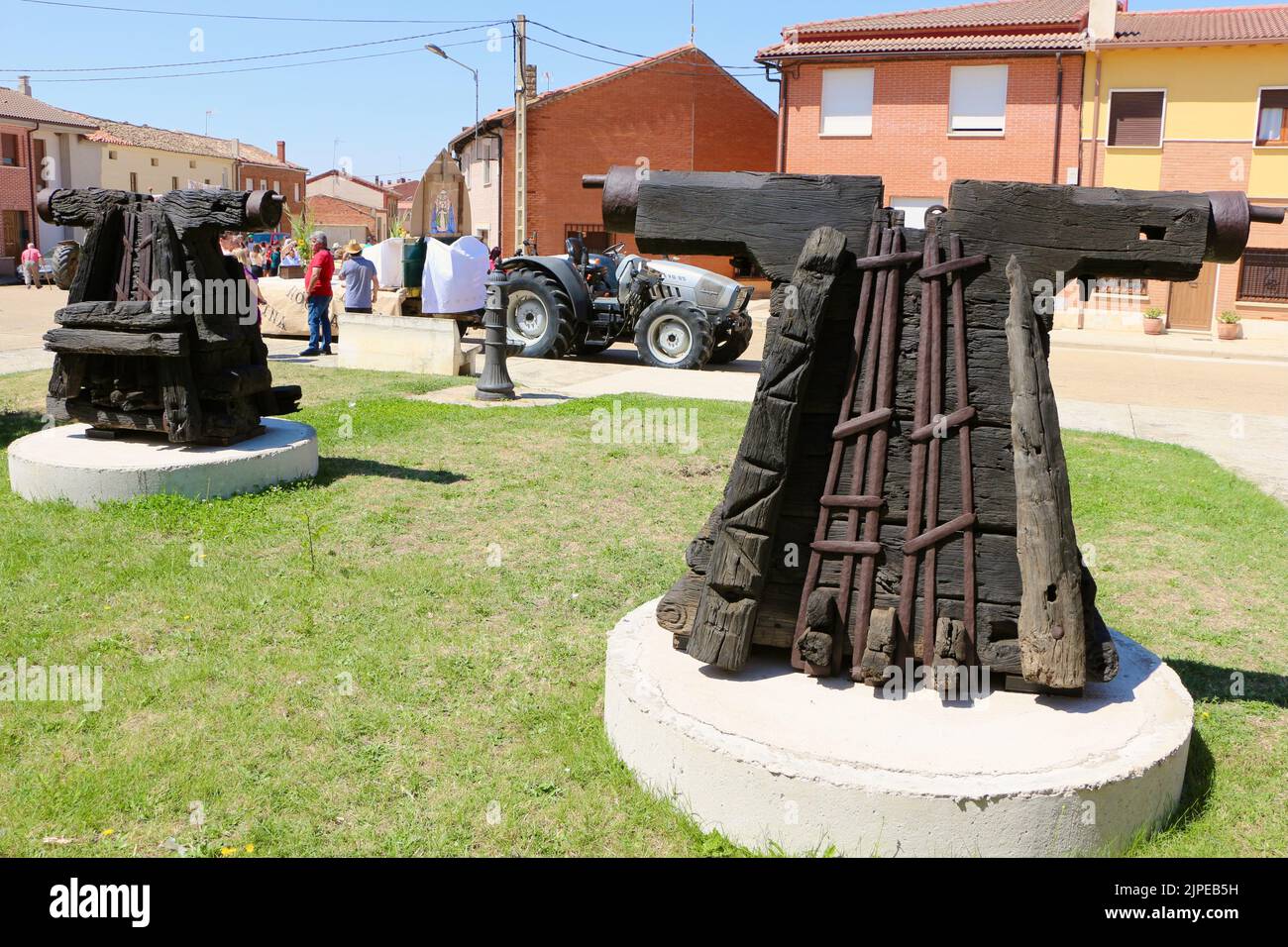 Two disused headstocks from the church in Lantadilla Palencia Spain nw on display with a Lamborghini tractor behind during the August fiestas Stock Photo