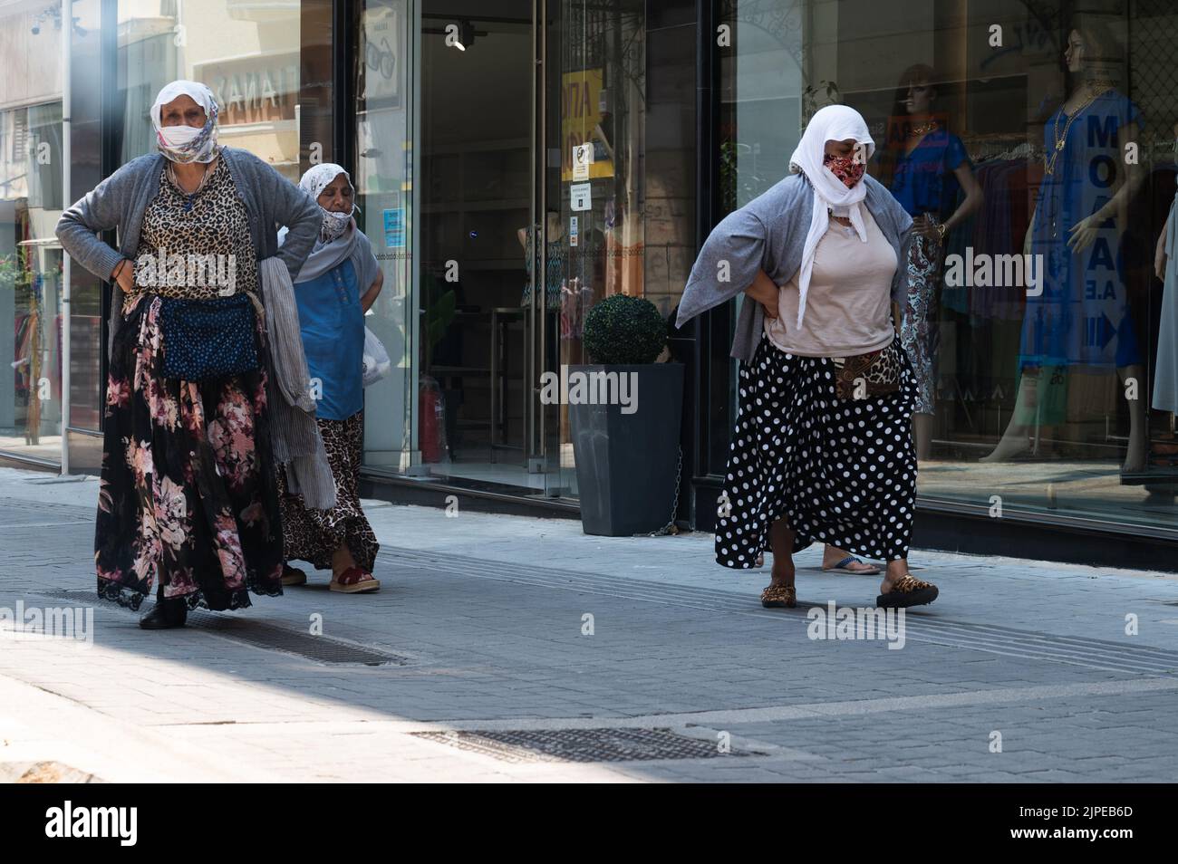 ATHENS, GREECE MAY 14, 2022 Women in headscarves and masks in the