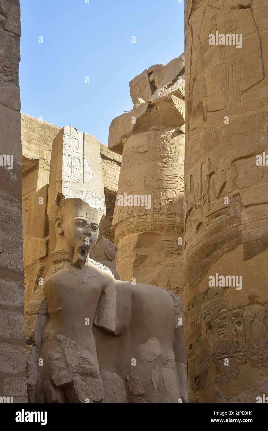 Ruins of Karnak Temple complex with sculptures, statues and columns ...
