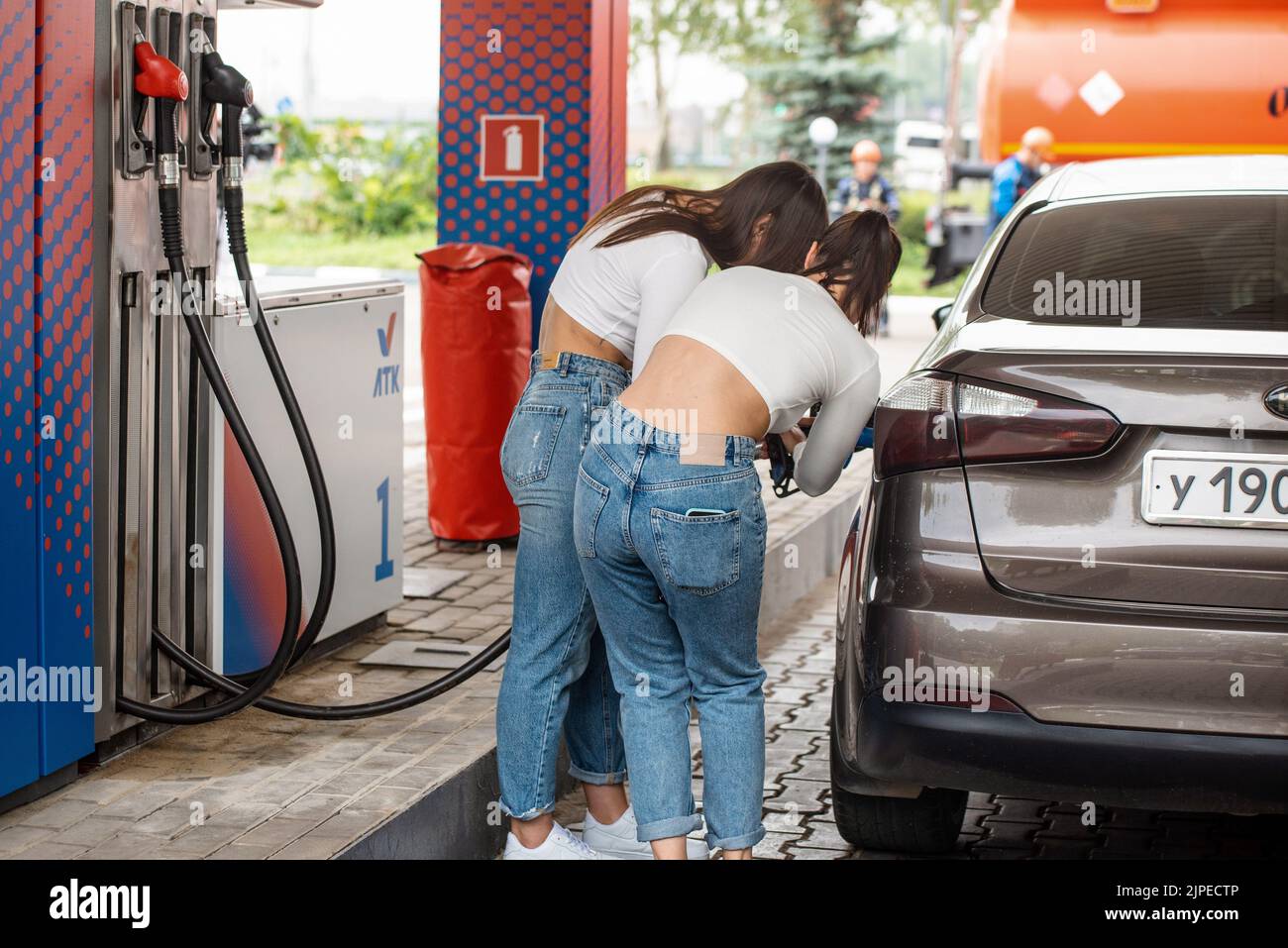 Genre photography. The work of the gas station 'Favorite Fuel Company' (LTK, owner - LLC 'TradeProject'). Girls while refueling a car with gasoline at a gas station. 04.08.2022 Russia, Lipetsk region, Lipetsk Photo credit: Oleg Kharseev/Kommersant/Sipa USA Stock Photo
