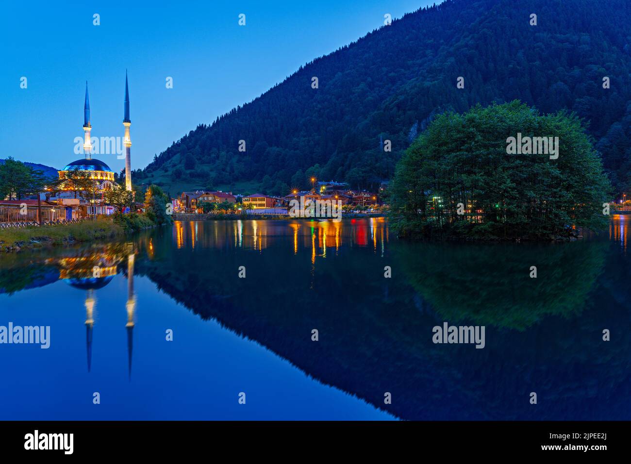 Uzungol Mosque and its reflection in water at the twilight in the mountain town of Uzungol, Turkey Stock Photo