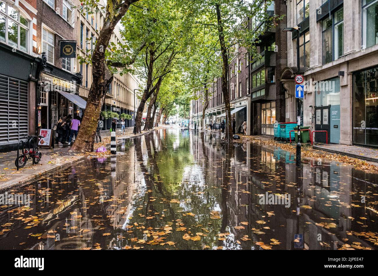 Flooded street in Central London after torrential rain storm, summer 2022, England, UK, weather. Stock Photo