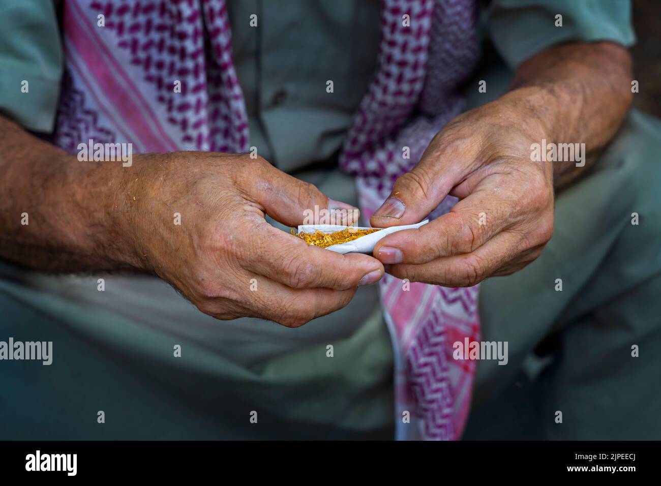 Hands rolling cigarette in the Southeastern Turkey Stock Photo