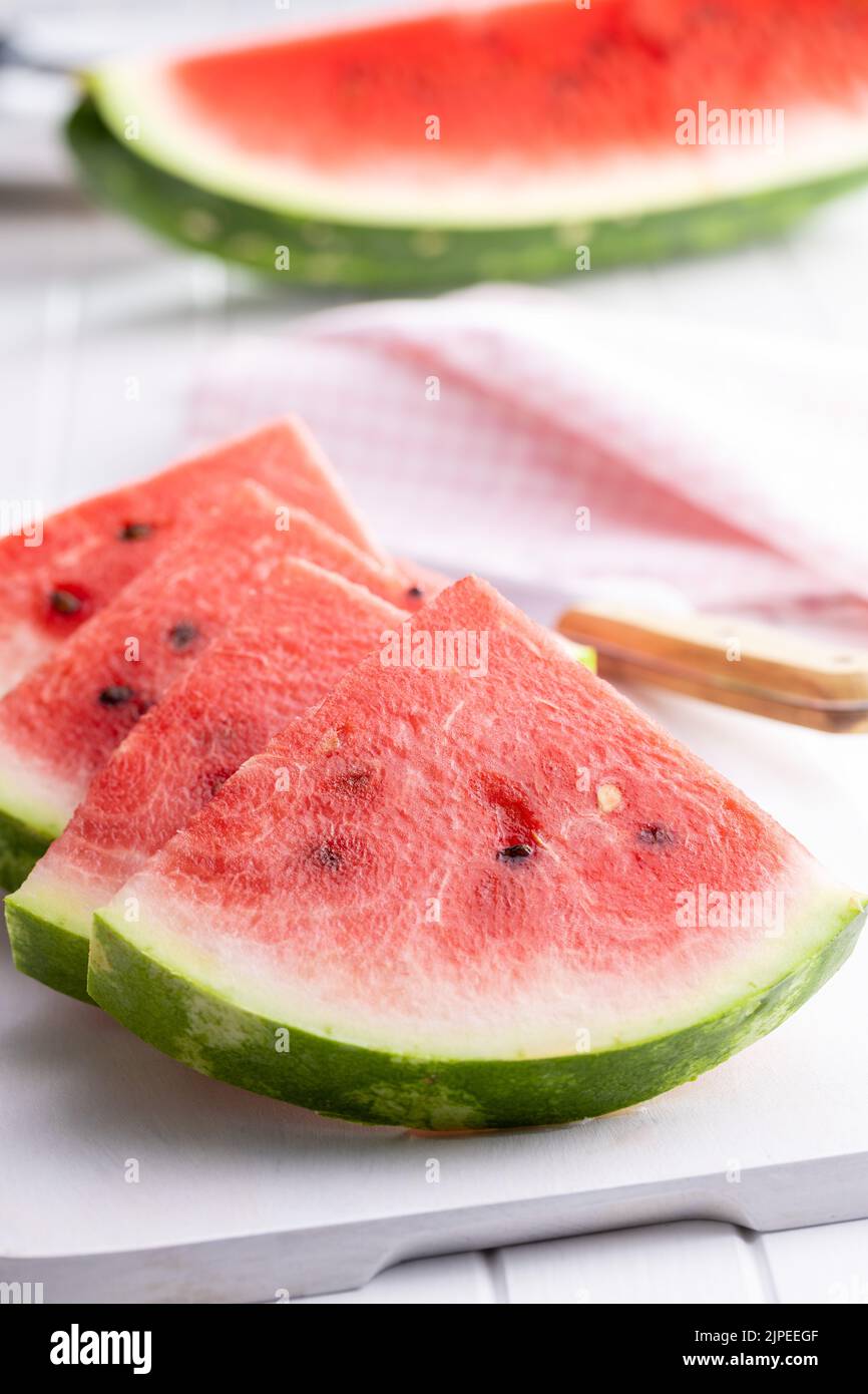 Slices of red watermelon on a cutting board. Stock Photo