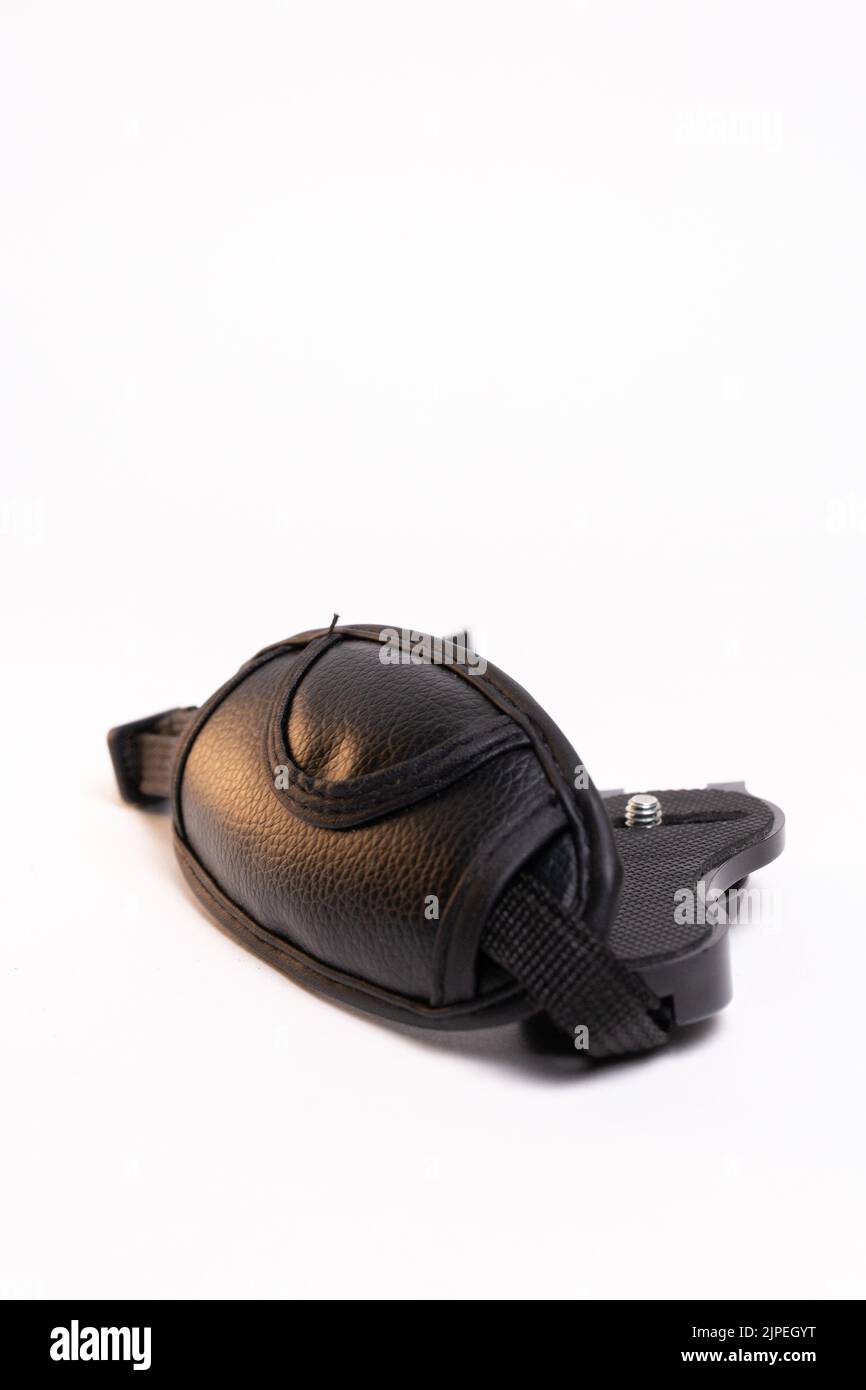 black leather camera strap on white background. Stock Photo