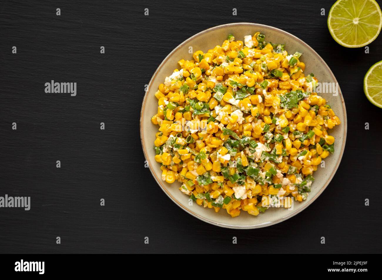 Homemade Mexican Street Corn Esquites on a Plate on a black background