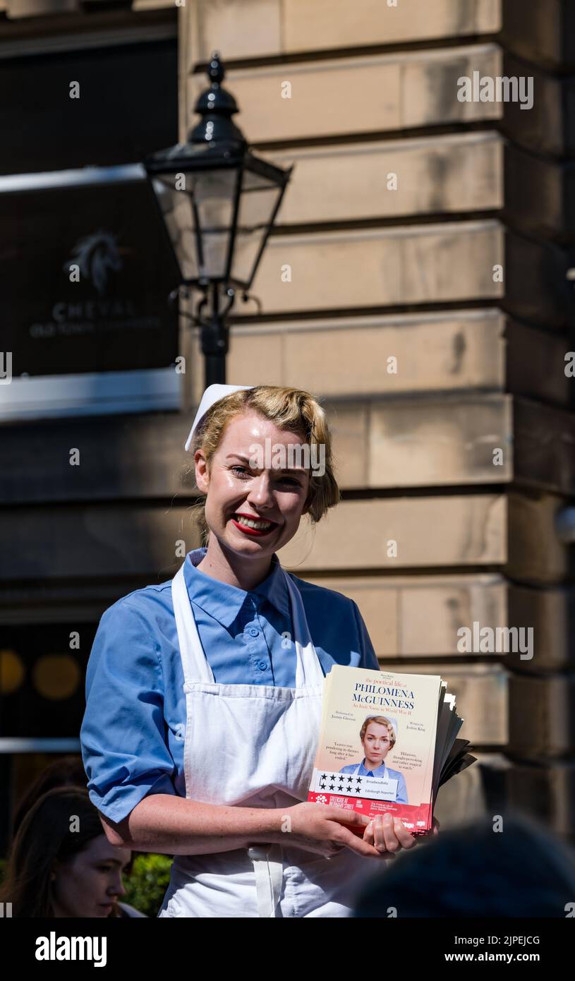 Royal Mile, Edinburgh, Scotland, UK, 17th August 2022. Performers on Royal Mile in the sunshine. Pictured: Philomema McGuinness Fringe show with an actor dressed in a nurse uniform. Credit: Sally Anderson/Alamy Live News Stock Photo