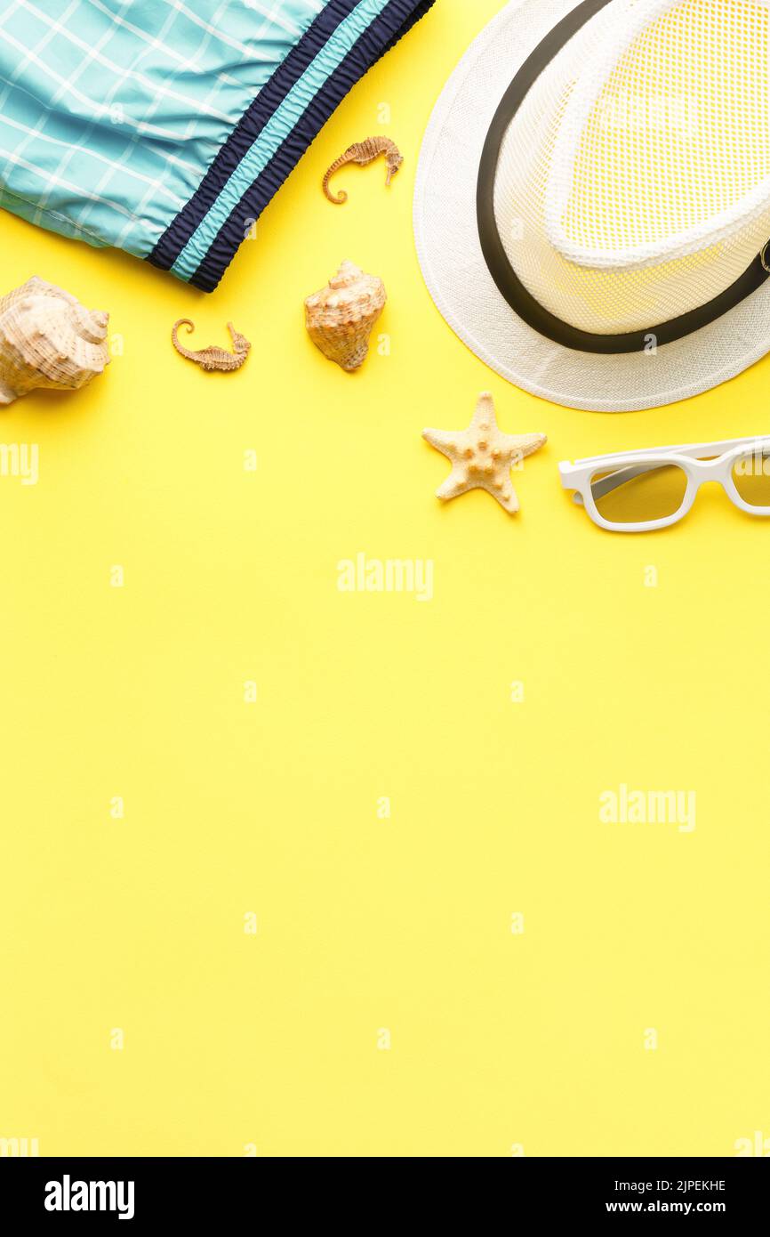 Summer hat with sunglasses on yellow background Stock Photo - Alamy