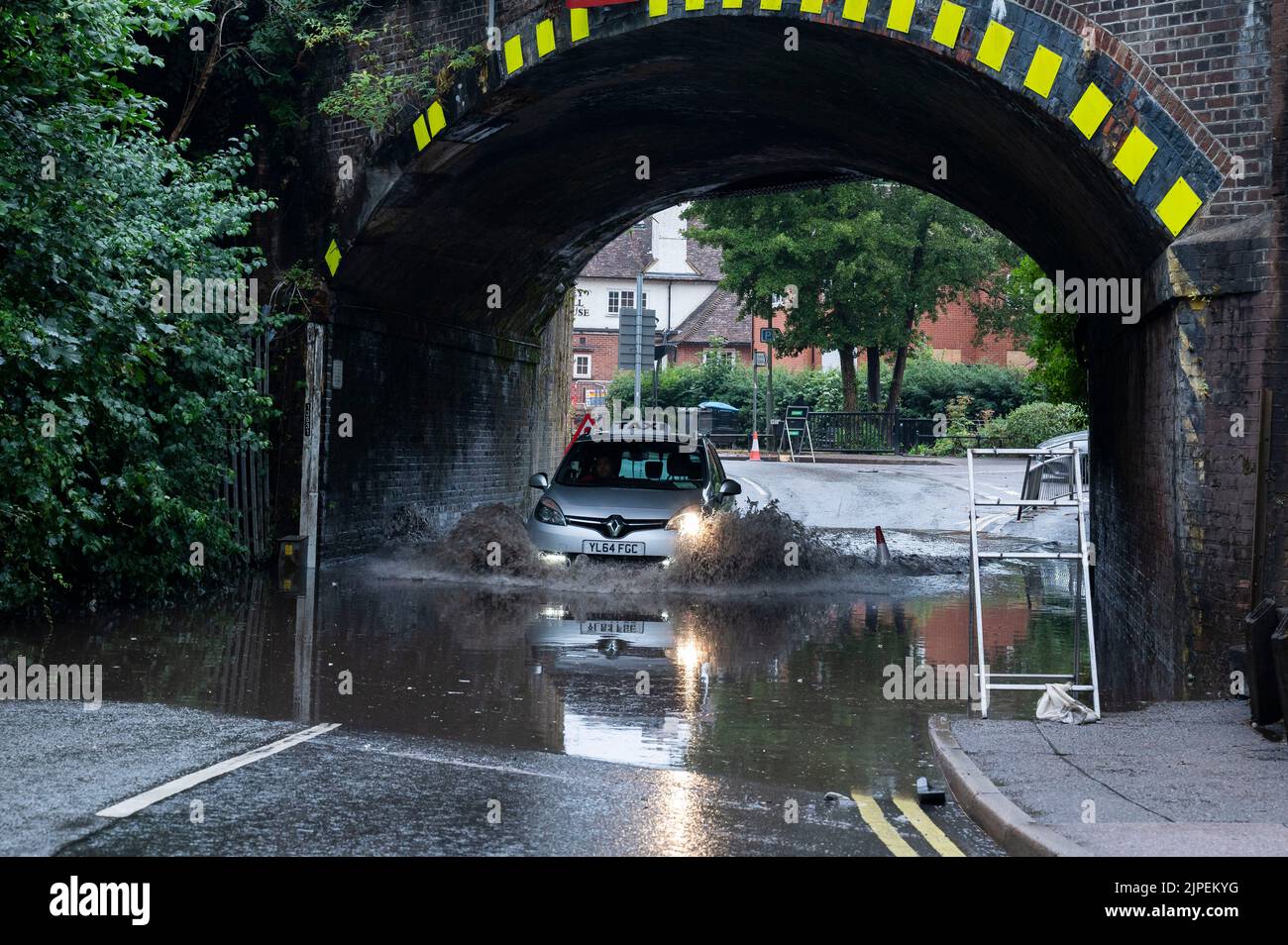 Haslemere, UK, Wednesday, 17th August 2022. A car drives under a railway bridge through a large flood after torrential rainfall brings the summer heatwave to an end, Weyhill, Haslemere, Surrey.  Credit: DavidJensen / Empics Entertainment / Alamy Live News Stock Photo
