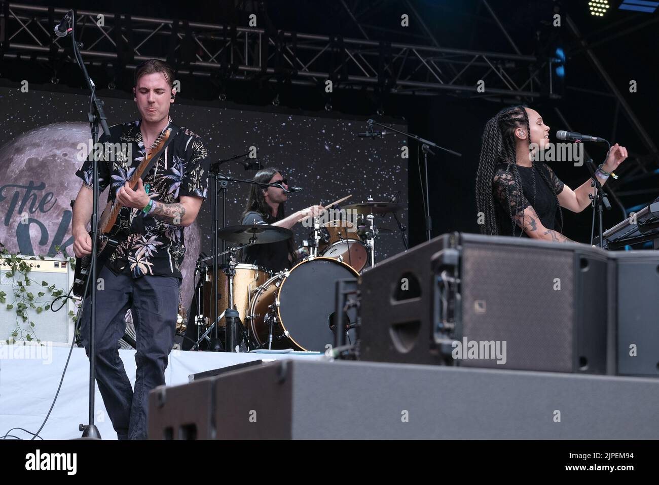 Winchester, UK. 14th Aug, 2022. (From L-R) Joshua Waters Rudge, vocalist and guitarist and Marcia Richards, female vocalist, alto saxophone and melodica player perform with British reggae punk band The Skints live on the Grand Central stage during the Fair Festival. Boomtown is a British music festival held every year on the Matterley Estate in South Downs National Park, near Winchester. Credit: SOPA Images Limited/Alamy Live News Stock Photo